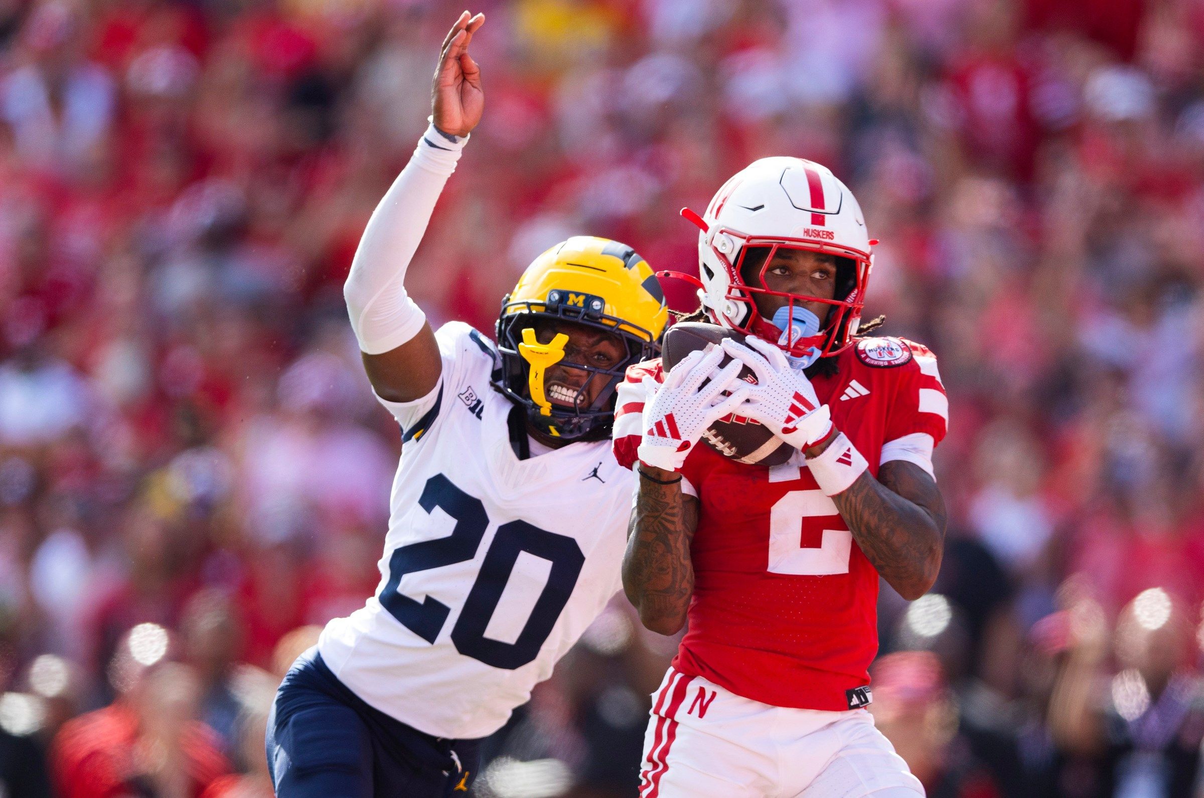 Nebraska's Jacory Barney Jr. (2) catches a touchdown pass ahead of Michigan's Jyaire Hill (20) during the first half of an NCAA college football game Saturday, Sept. 20, 2025, in Lincoln, Neb.