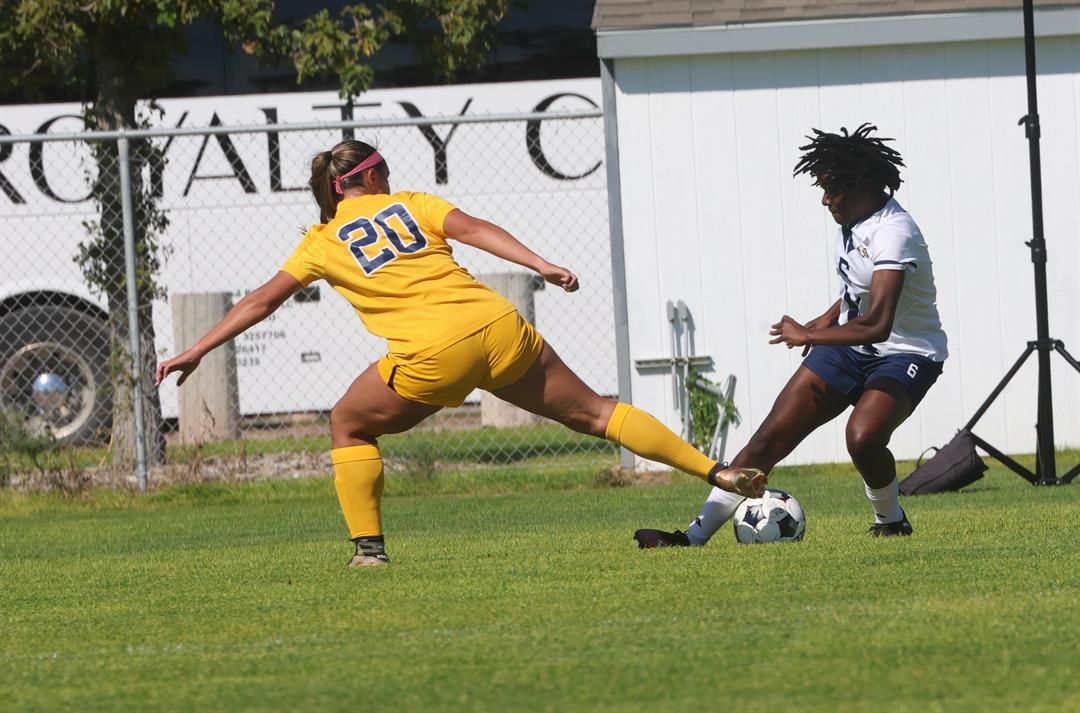 WNCC's Aeisha Lashley fights for the ball against LCCC's Emma Cortez. LCCC won 7-0.