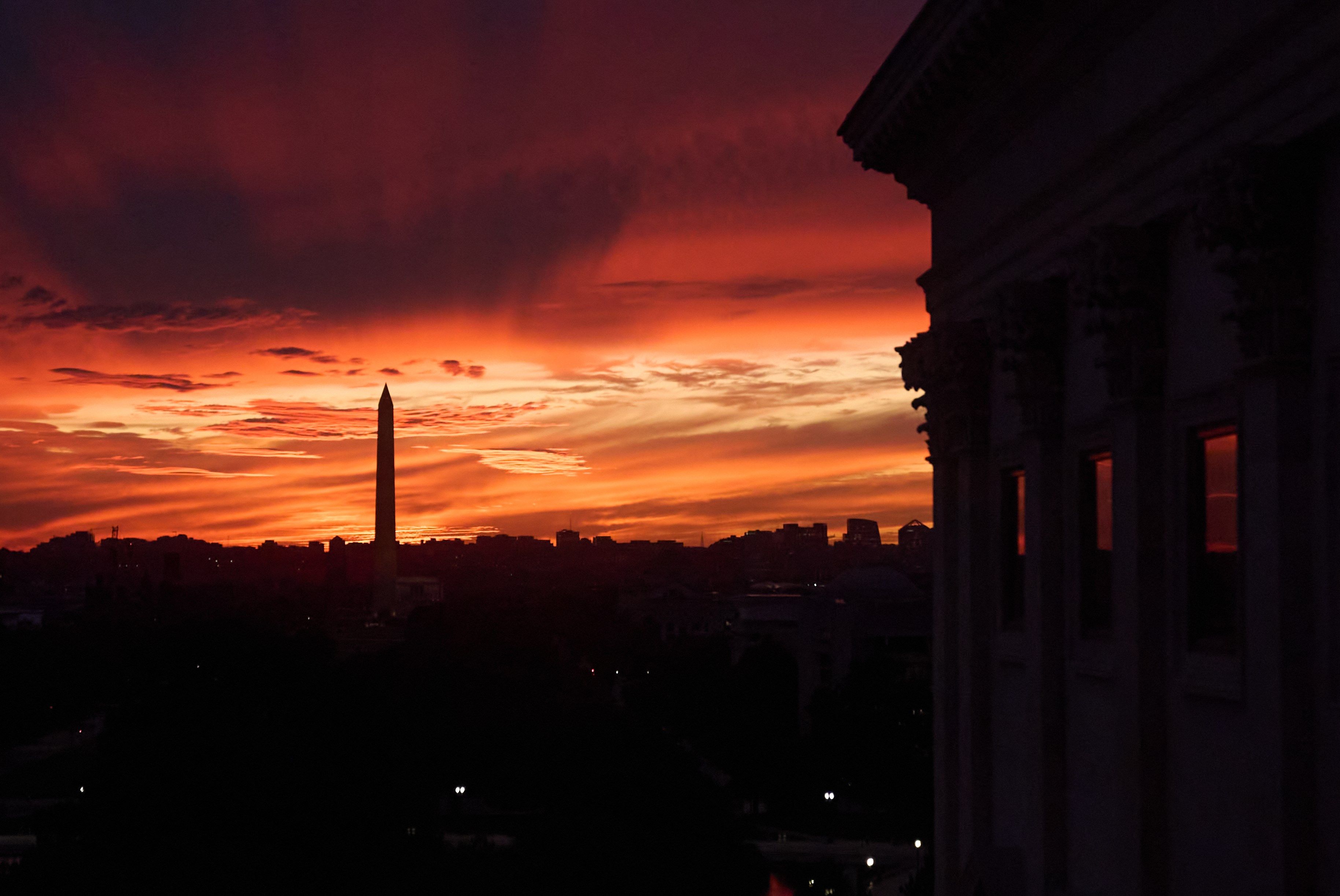 The sunset is seen from the Capitol before Republican and Democratic news conferences about the government shutdown, Tuesday, Sept. 30, 2025, on Capitol Hill, in Washington.