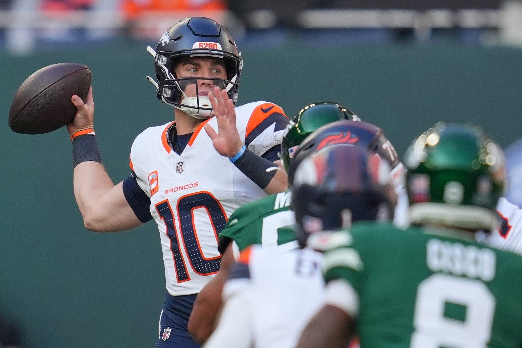 Denver Broncos quarterback Bo Nix passes the ball in the first half of an NFL football game between the Denver Broncos and the New York Jets, Sunday, Oct. 12, 2025, in London.