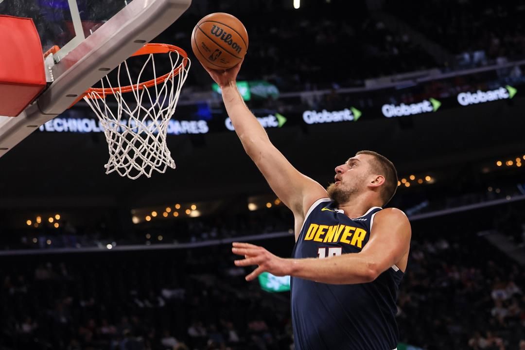 Denver Nuggets center Nikola Jokic scores during the first half of a preseason NBA basketball game against the Los Angeles Lakers, Sunday, Oct. 12, 2025, in Inglewood, Calif.