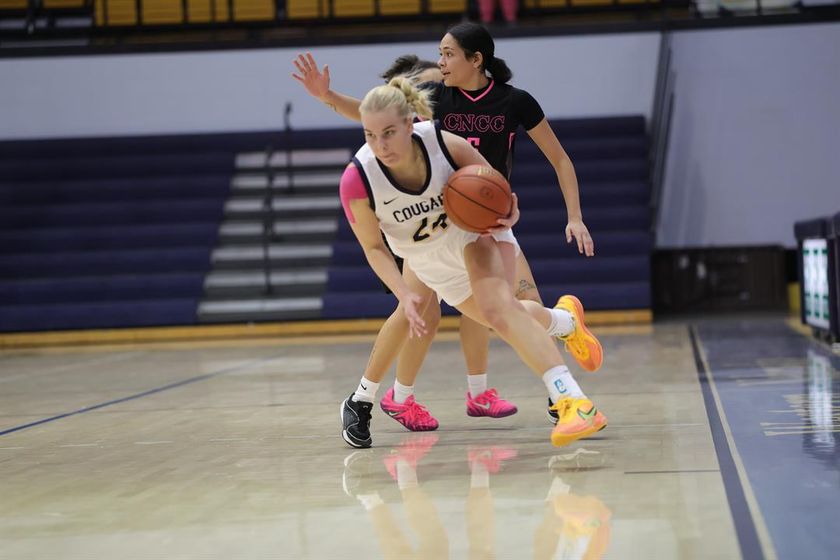 WNCC's Zozefine Sipolina drives past a CNCC defender on the way up the court.