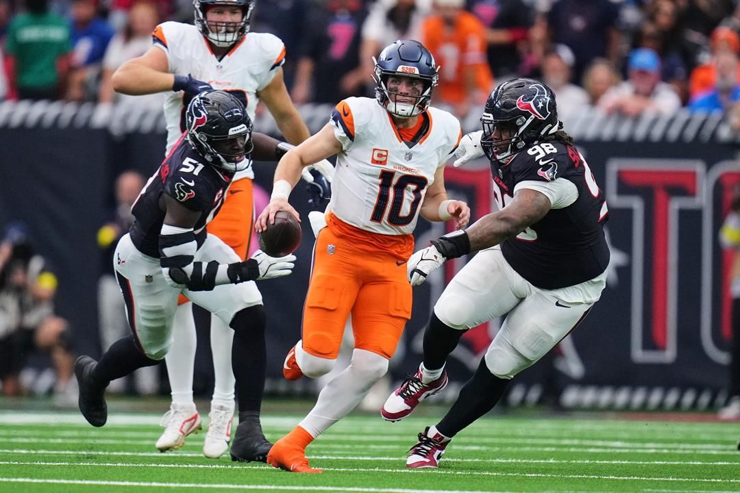 Denver Broncos quarterback Bo Nix (10) escapes pressure from Houston Texans defensive end Will Anderson Jr. (51) and Tim Settle Jr. (98) as Nix runs the ball for a long gain in the second half of an NFL football game Sunday, Nov. 2, 2025, in Houston.