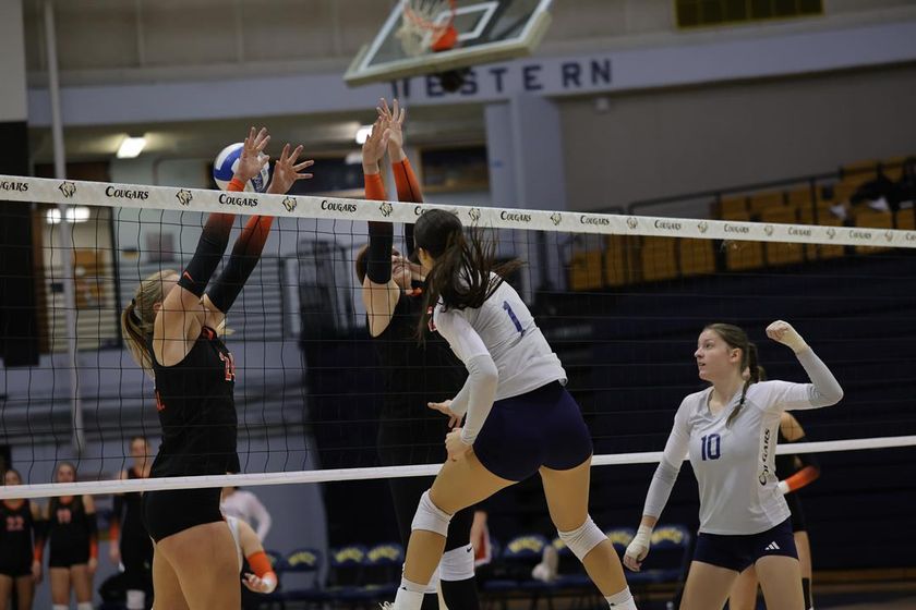 WNCC's Anika Davison hits the ball past a double block of Central Wyoming in the third day of the regional tourney