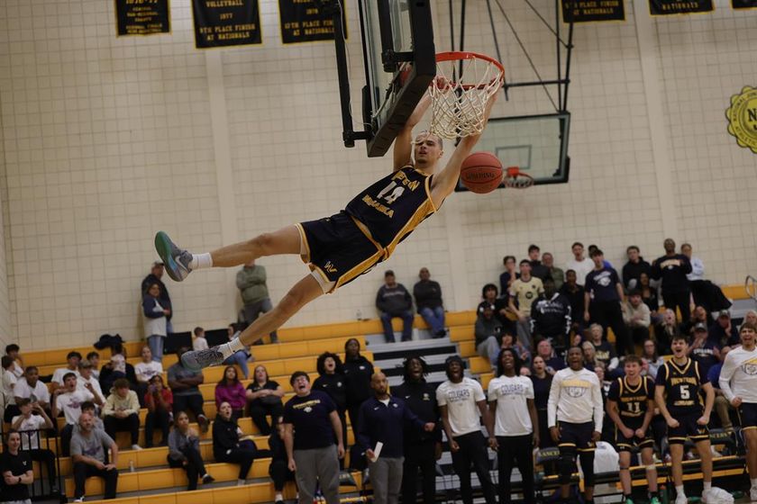 WNCC's Xavier Kirkpatrick goes up for a shot while being guarded by an EWC player.