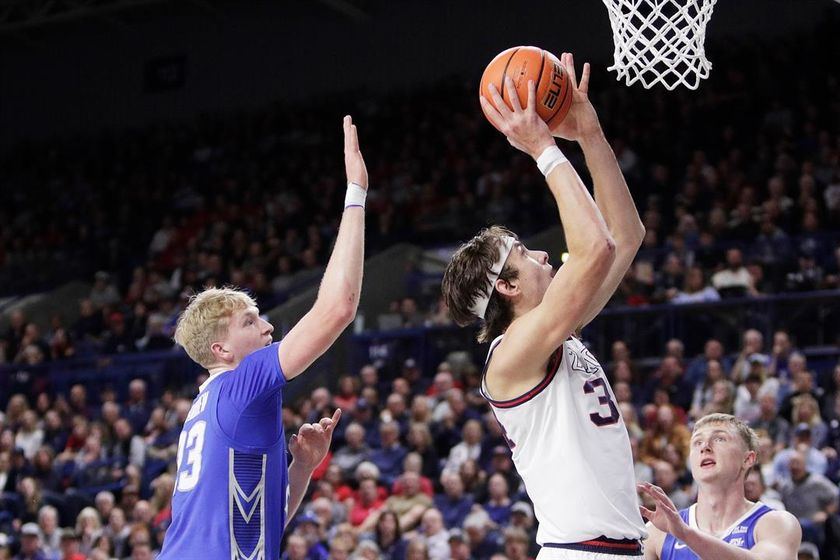 Gonzaga forward Braden Huff, right, shoots while pressured by Creighton forward Jackson McAndrew during the first half of an NCAA college basketball game, Tuesday, Nov. 11, 2025, in Spokane, Wash.