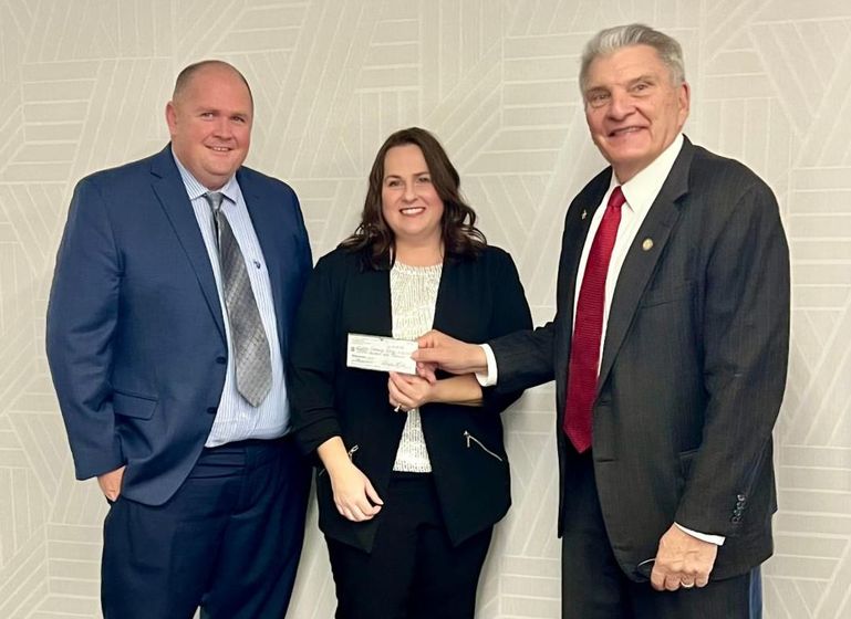 WNCC President Greg Dart and Board Chair John Stinner (right) accept a check for $15,000 from NPPD Account Manager Jennifer Branson. The funds were raised from the 34th annual Wells Fargo Nebraska Open in the fall.