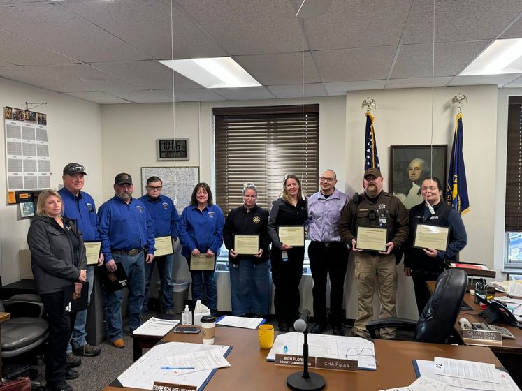 Kimball County first responders stand with the patient whose life they saved, Nicholas Bowles, after receiving the Life Saving Award at the Commissioners Meeting Tuesday morning.