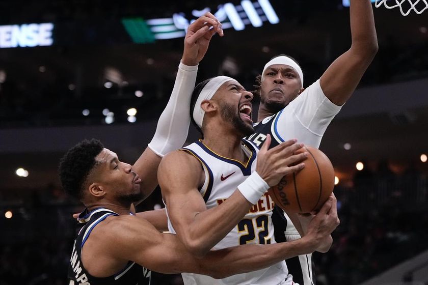 Denver Nuggets' Zeke Nnaji looks to shoot past Milwaukee Bucks' Giannis Antetokounmpo and Myles Turner during the first half of an NBA basketball game Friday, Jan. 23, 2026, in Milwaukee.